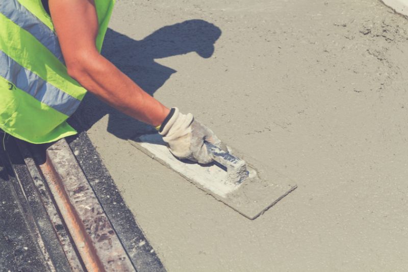 concrete worker finishing concrete surface